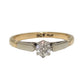 Two-tone gold ring with a diamond on a white background