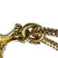 Close-up of a gold chain with intricate design on a white background