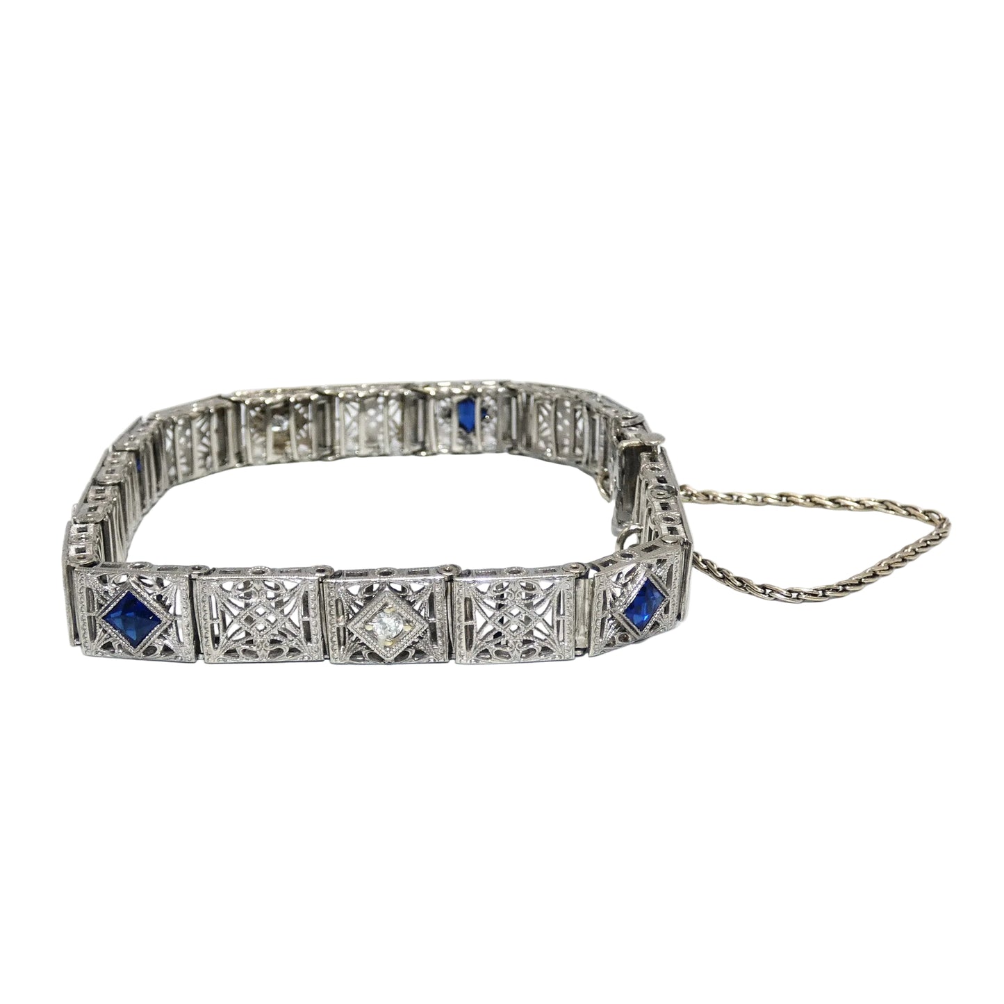 White gold bracelet with blue sapphires and diamonds on on a white background