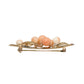 A vintage gold brooch shaped like a cluster of peach-colored corals.