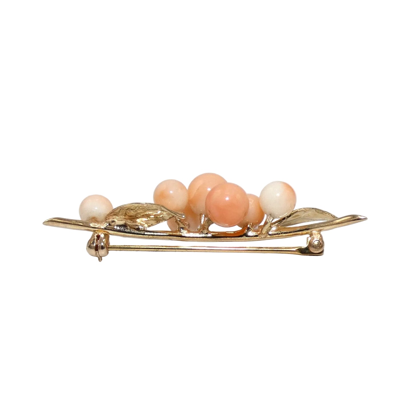 A vintage gold brooch shaped like a cluster of peach-colored corals.