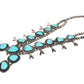A Southwestern-style turquoise and silver necklace featuring oval and teardrop-shaped turquoise stones set in oxidized sterling silver