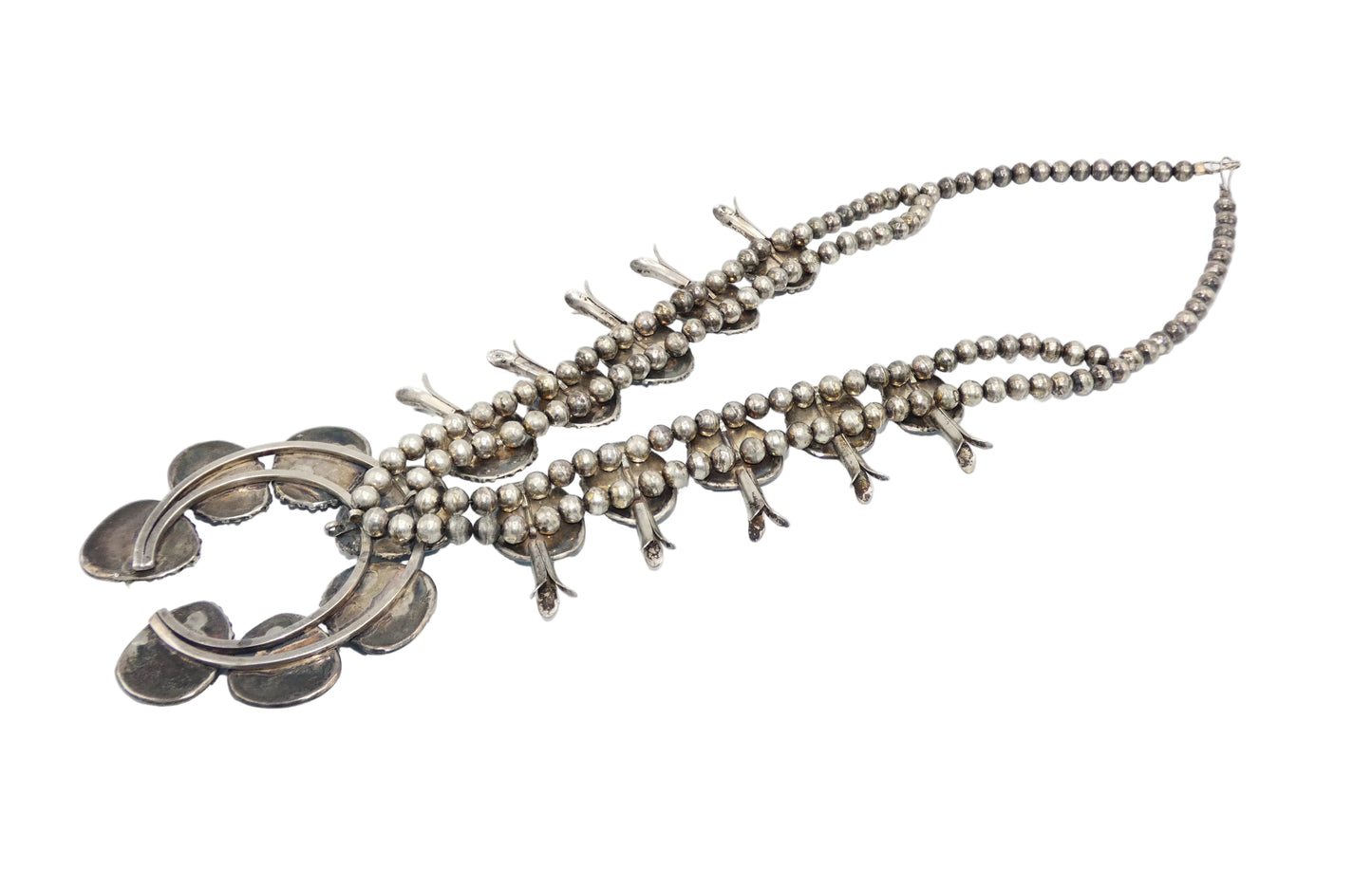A Southwestern-style turquoise and silver necklace featuring oval and teardrop-shaped turquoise stones set in oxidized sterling silver