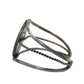A silver open cuff bracelet with textured twisted wire bands and a flat rectangular end featuring engraved detailing