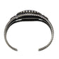 A sterling silver cuff bracelet with a textured, twisted rope-like design