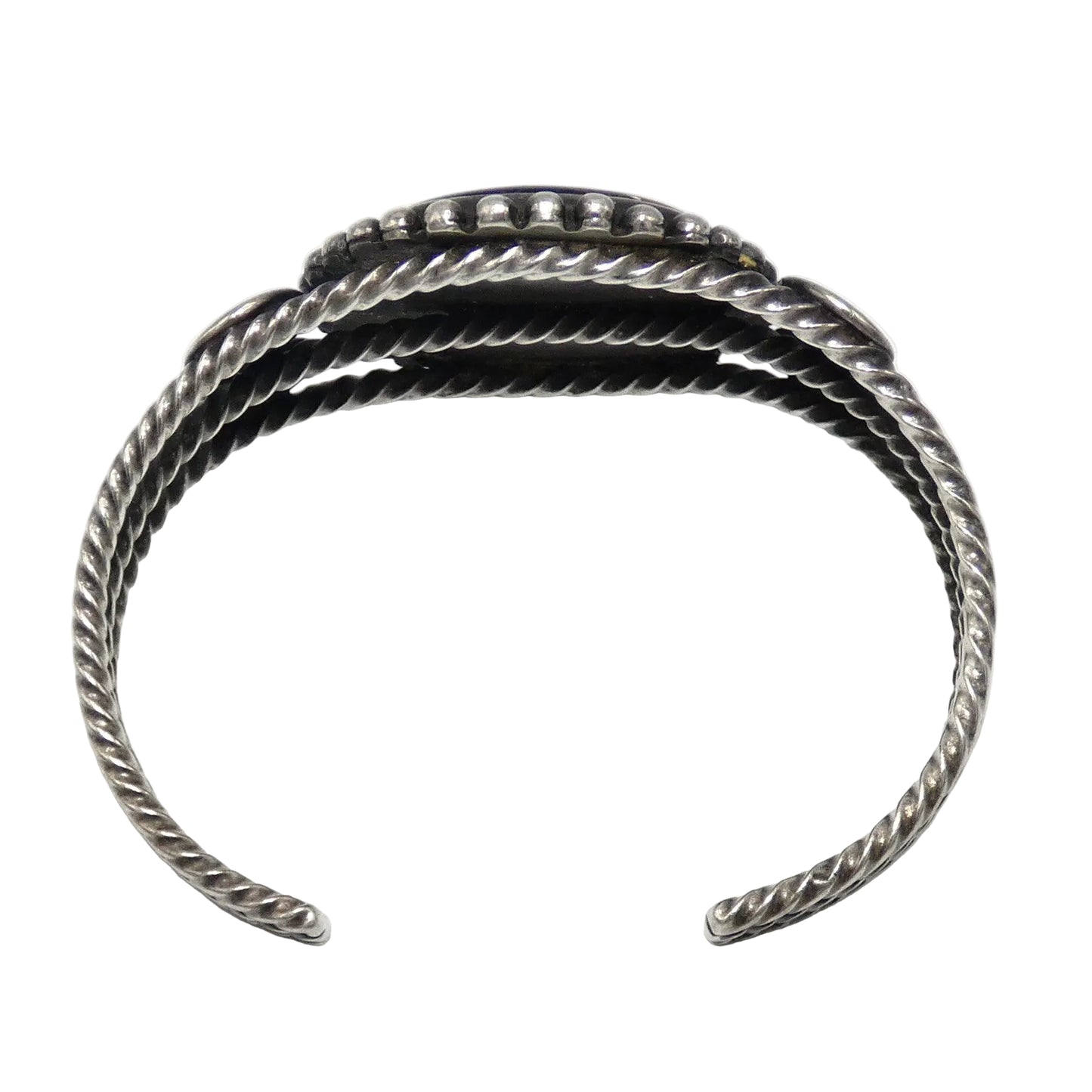 A sterling silver cuff bracelet with a textured, twisted rope-like design