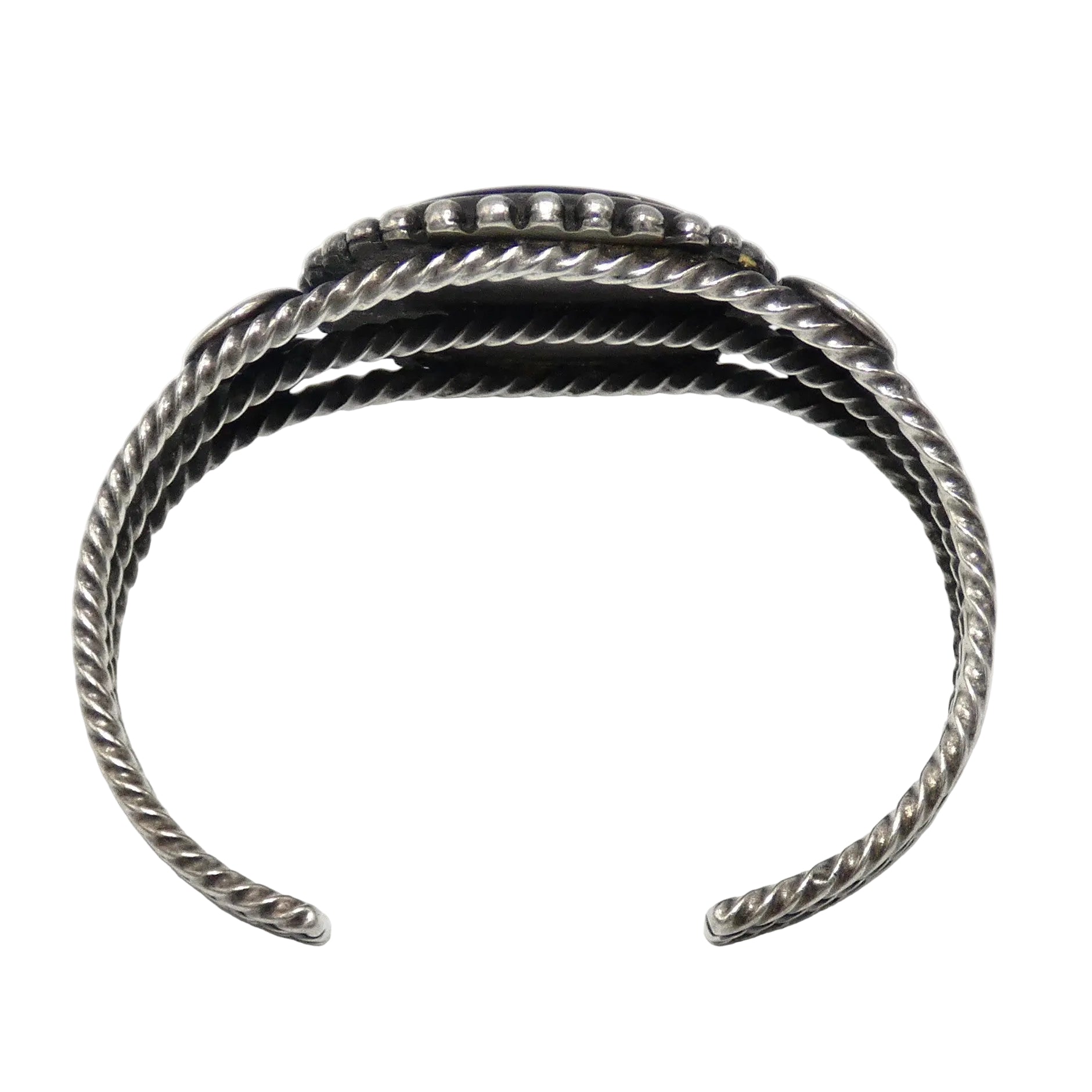 A sterling silver cuff bracelet with a textured, twisted rope-like design