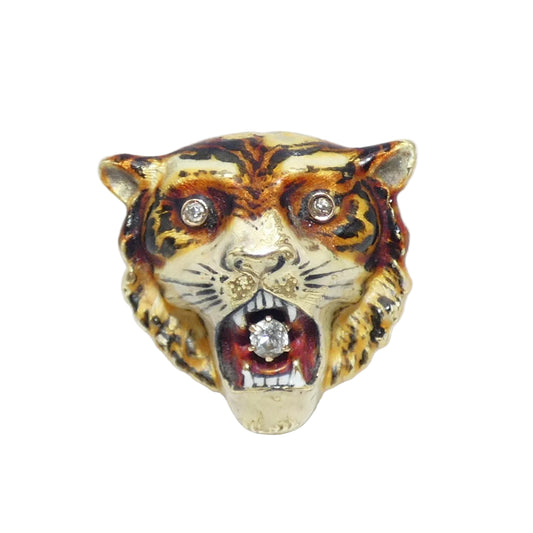 A tiger head brooch pin featuring a gold base with black and brown enamel stripes, a red interior, and diamond set in the eyes and mouth