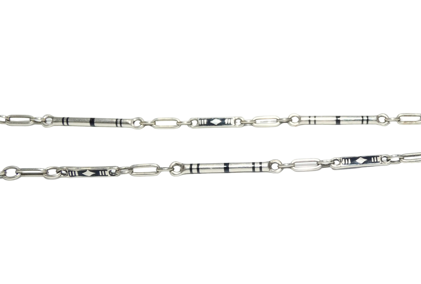 A 14k white gold pocket watch chain featuring geometric inlay details