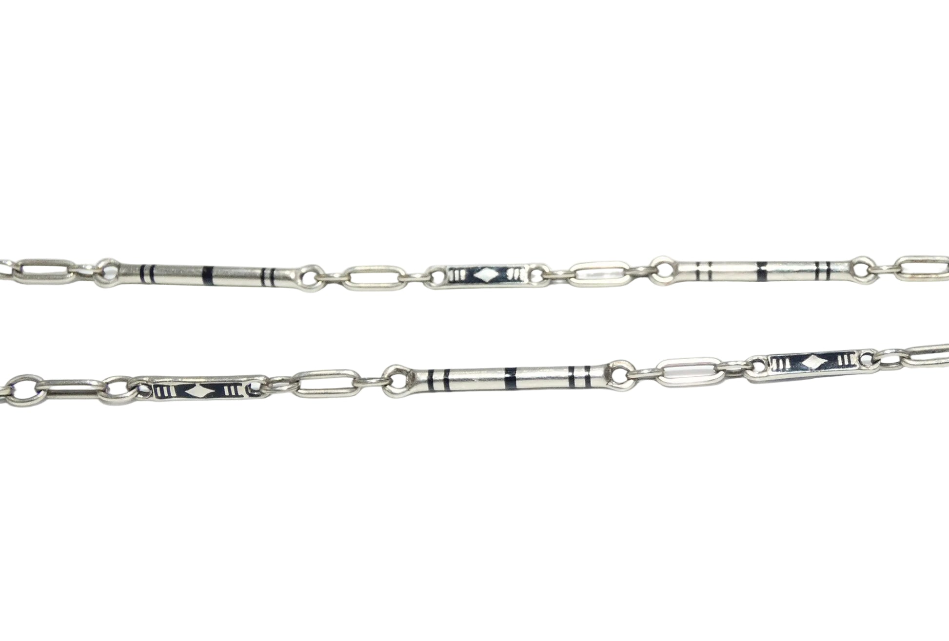 A 14k white gold pocket watch chain featuring geometric inlay details