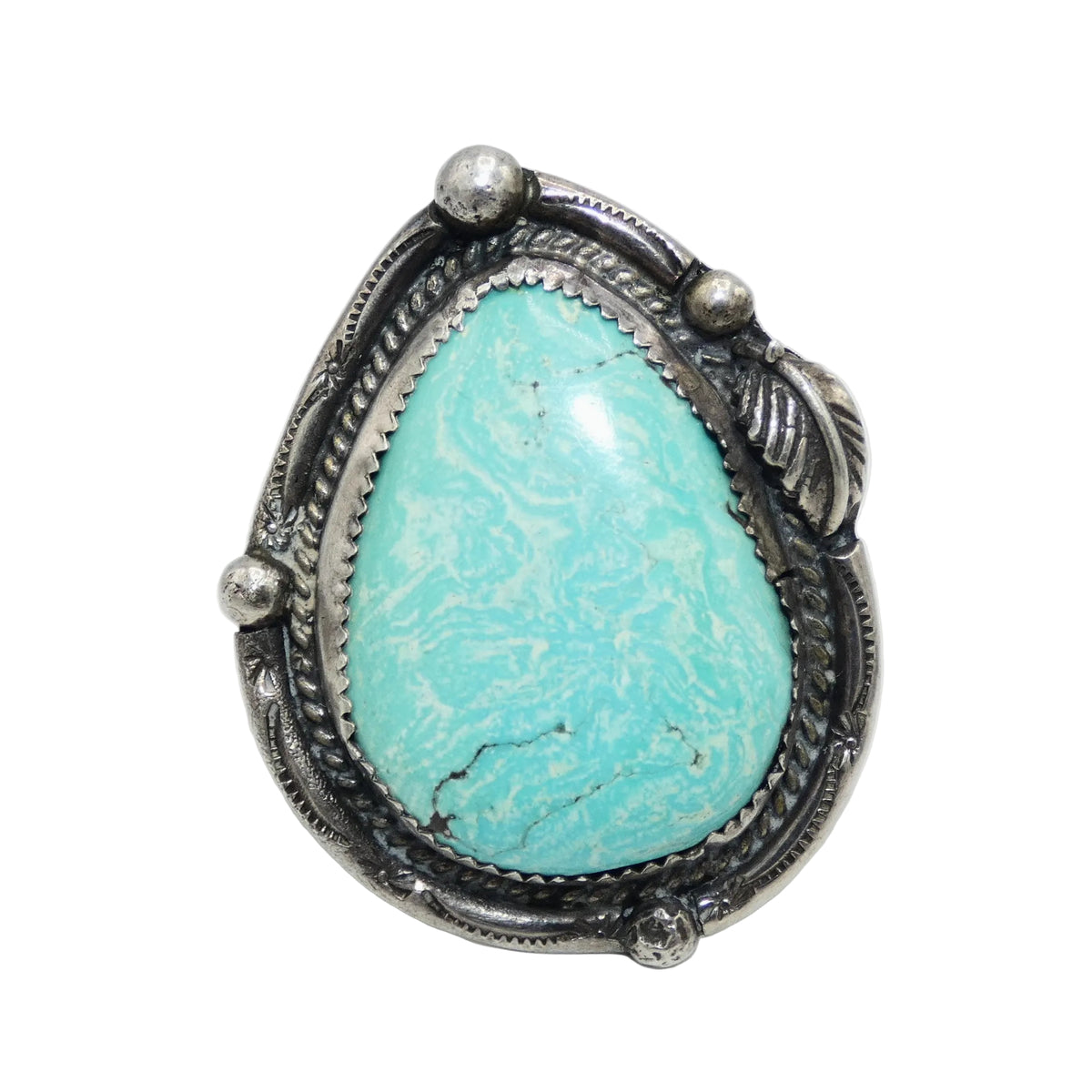 A sterling silver ring featuring a large, teardrop-shaped turquoise stone with natural white veining