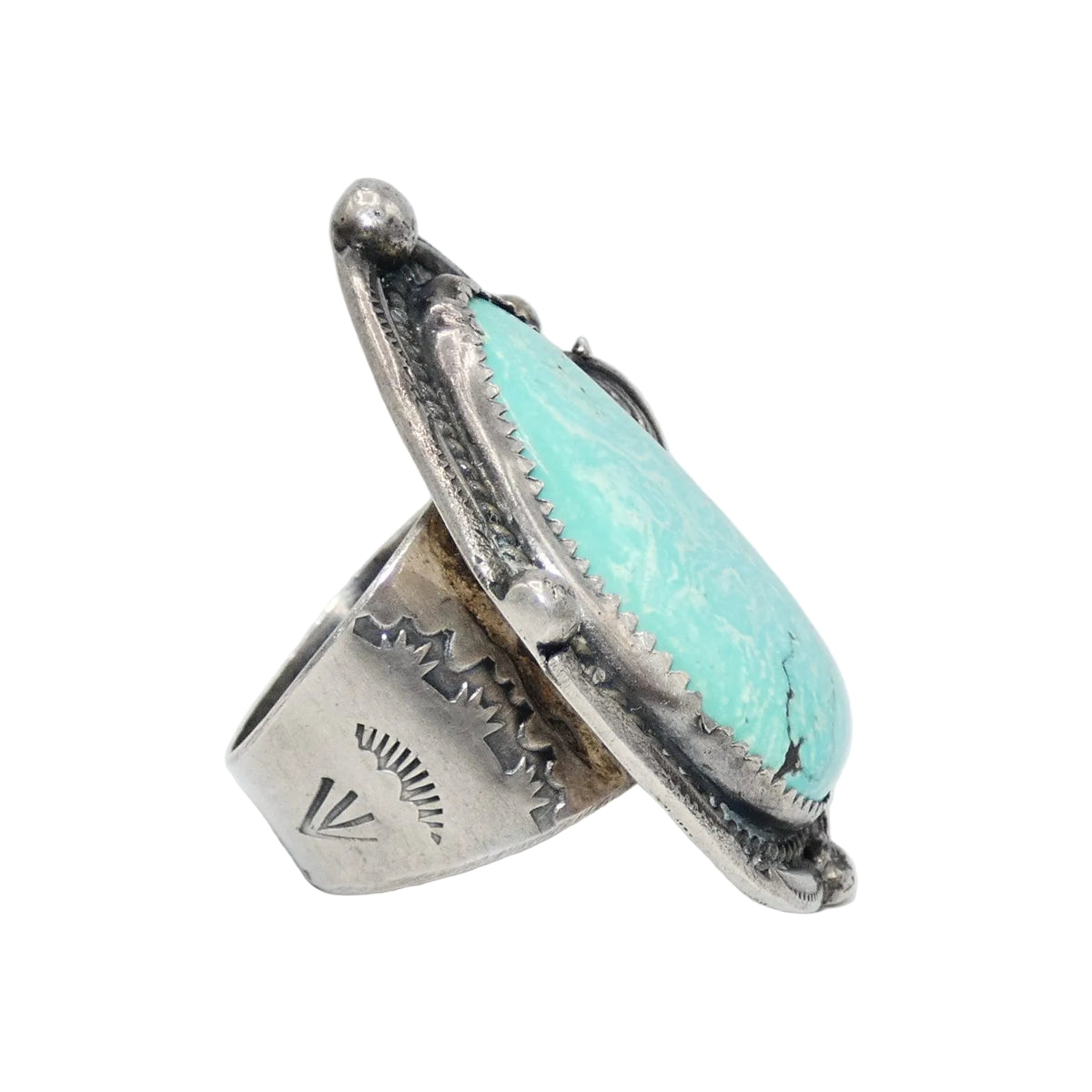 A sterling silver ring featuring a large, teardrop-shaped turquoise stone with natural white veining