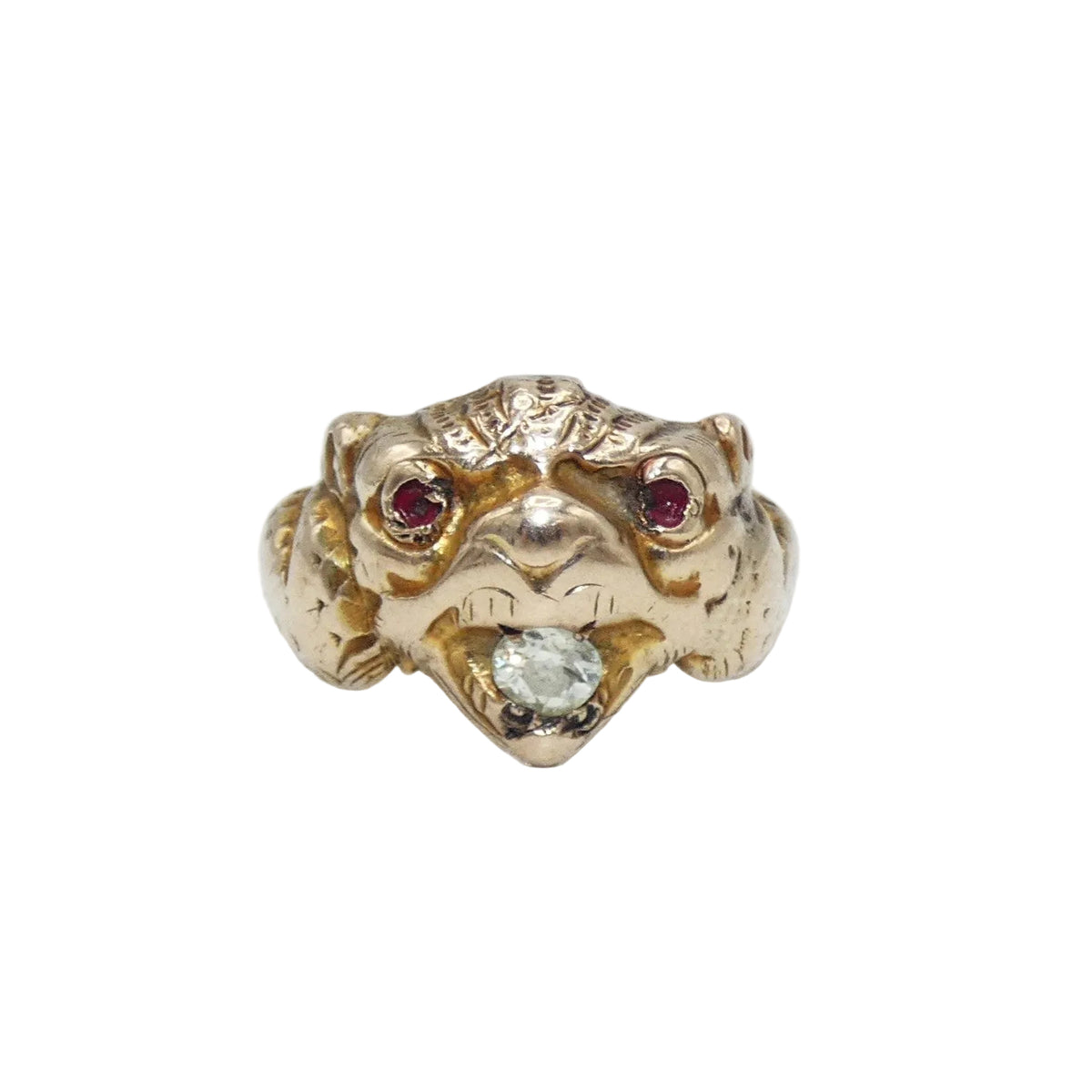 A gold ring shaped like a animal head or creature face, featuring small ruby eyes and a diamond in its mouth